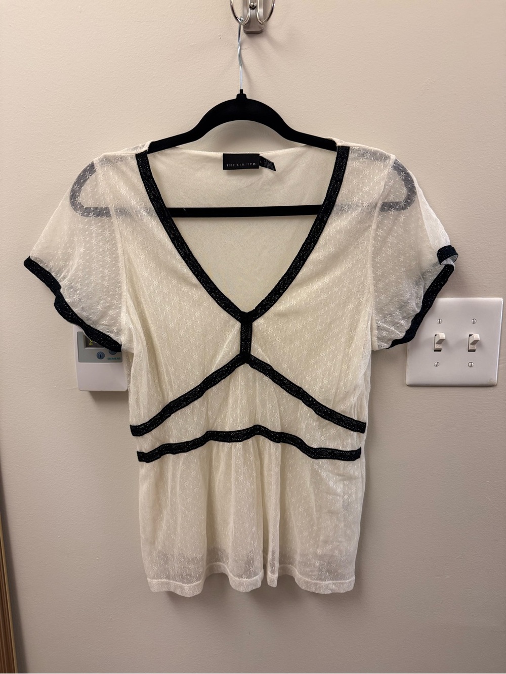 white semi-sheer top with black trims